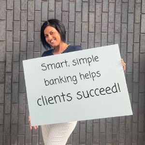 Smiling woman holding sign